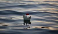 Paper boat with red flag