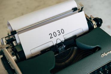 Typewriter with paper saying "2030“