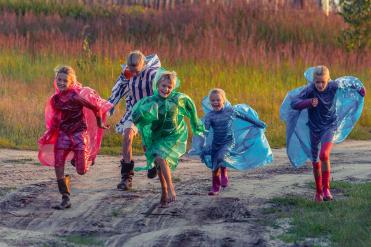 Children dressed in multicolor raincoats